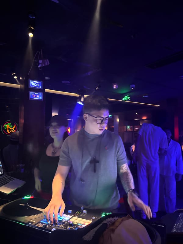 DJ set at Liangjiang nightclub with dancing crowd