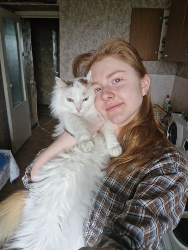 Young woman holds fluffy cat in Yekaterinburg