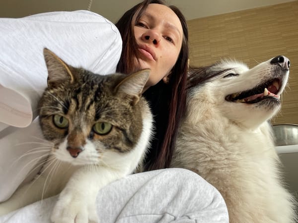 Woman poses with cat and dog in Izhevsk selfie