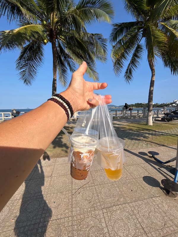 Person carries drinks on Nha Trang street morning
