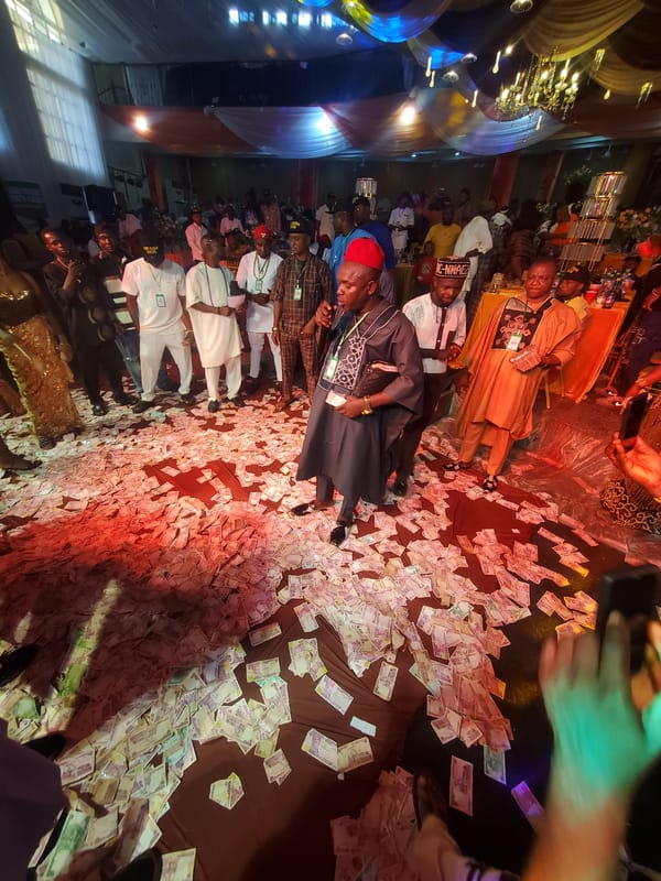 Currency scattered on floor draws crowds in Onitsha