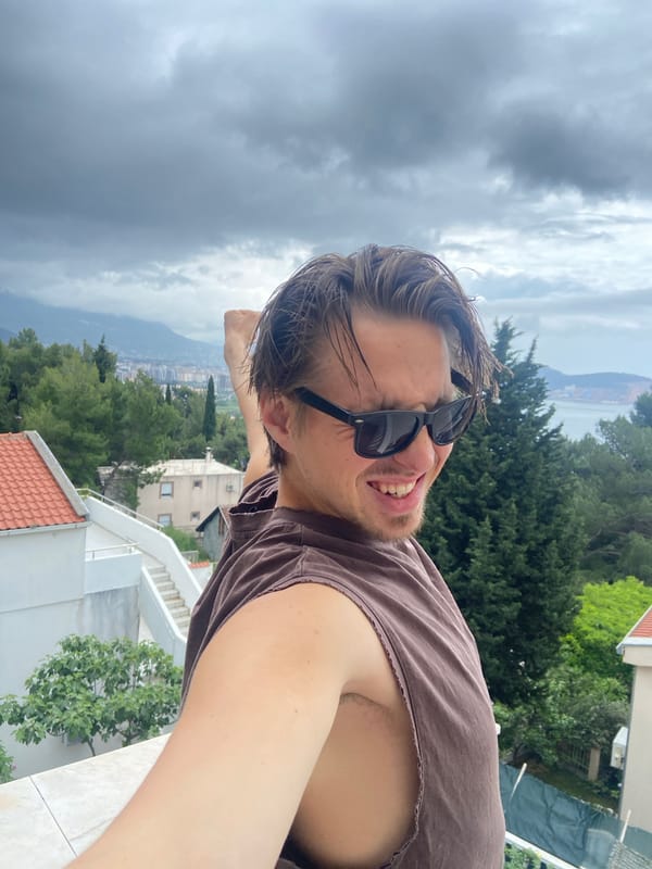 Man poses on Montenegro balcony during family time moment