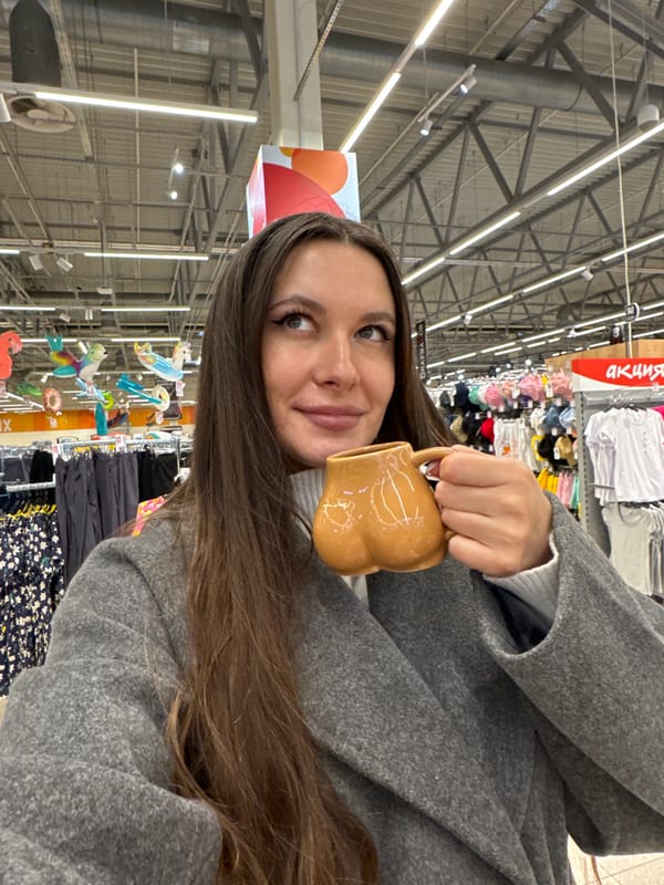 Woman photographed with mug in Юdino retail store