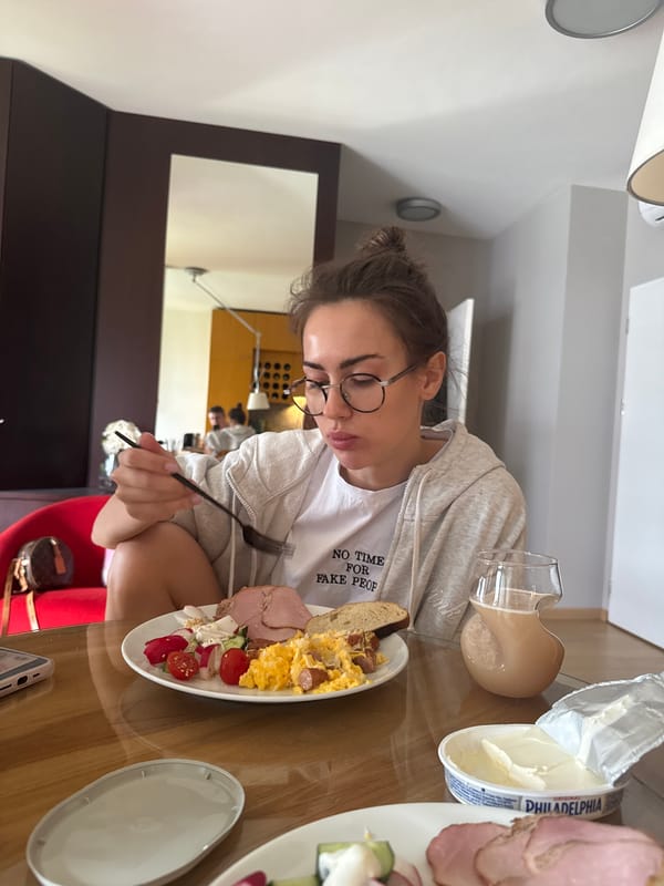 Woman dining and kitchen activity captured in indoor setting