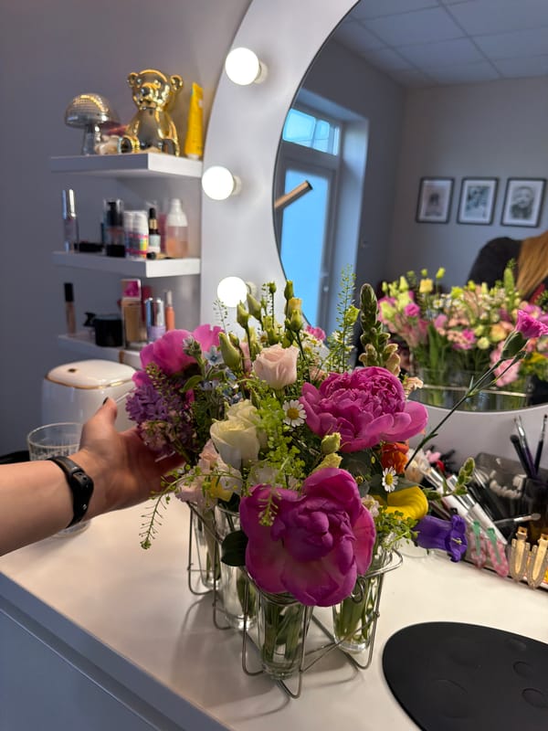 Woman takes flower bouquet selfies at Riga vanity area
