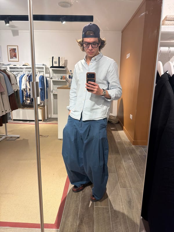 Customer takes mirror selfie in London clothing store