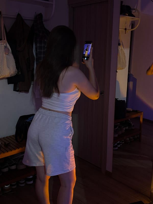 Casual evening in a blue-lit room, selfies and wine.