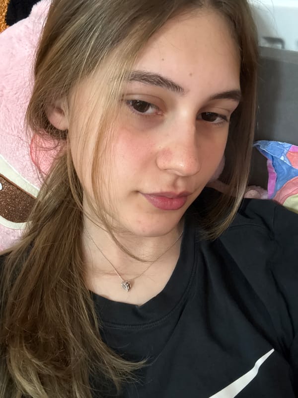Young woman takes playful selfies in Bulgarian bedroom