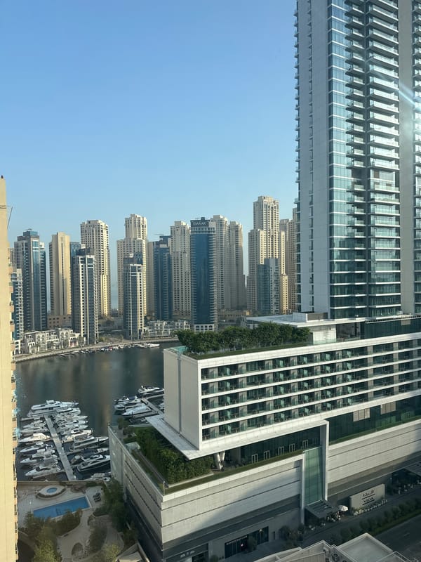Dubai Marina skyline views with an electrolyte drink in hand