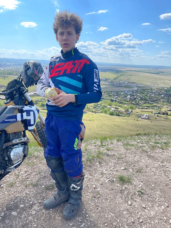 Teen dirt biker spotted on hillside overlooking Солонцы, Russia