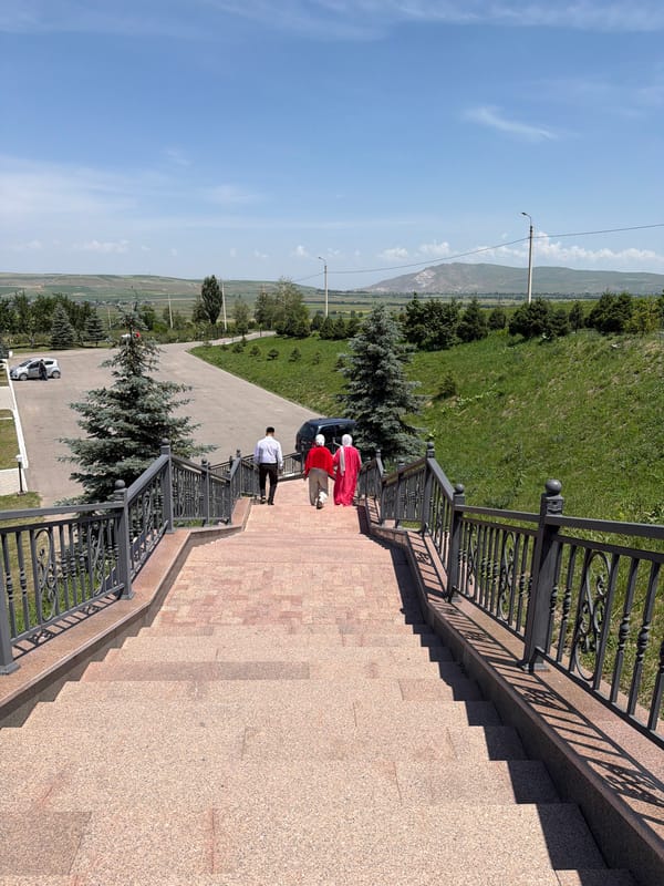 Morning visitors explore memorial site and scenic mountain landscape