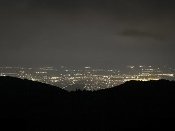 Moonlit hillside gathering above Sofia's glowing nightscape