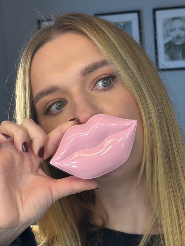 Woman takes selfies while doing makeup in Riga