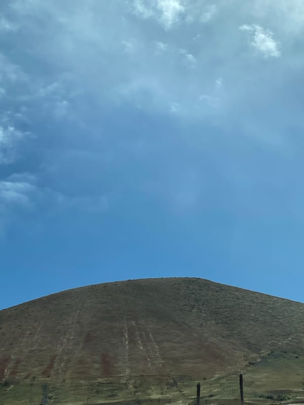 Hill or stone structure observed under cloudy sky in Yaiza