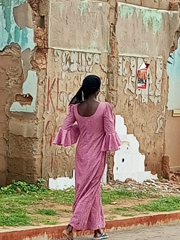 Street scenes: worn building exterior and scooter rider in motion