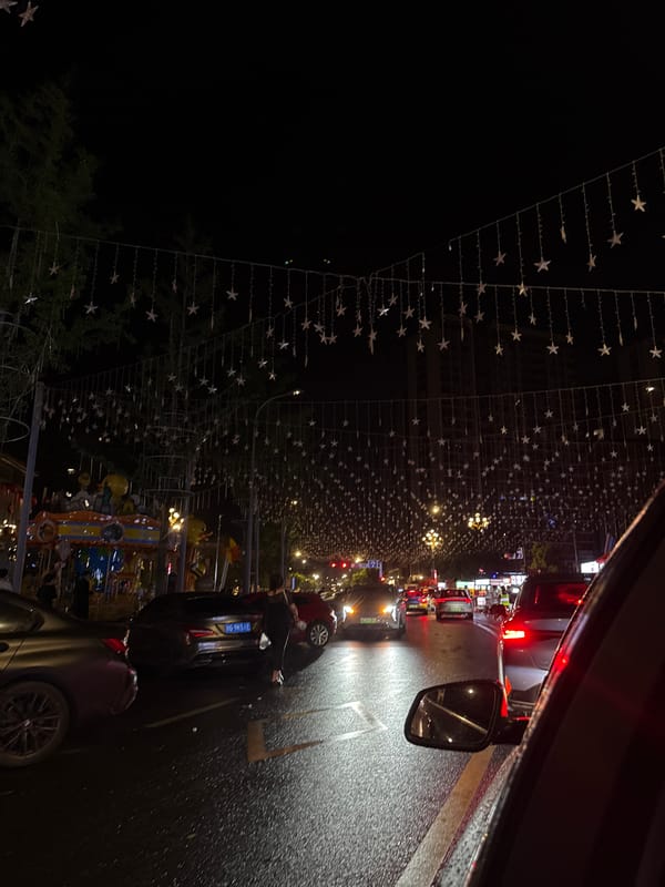 Yiwu street buzzes at night under star-shaped lights and a glowing carousel