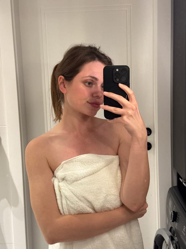 Bathroom mirror selfie in a modern tiled space