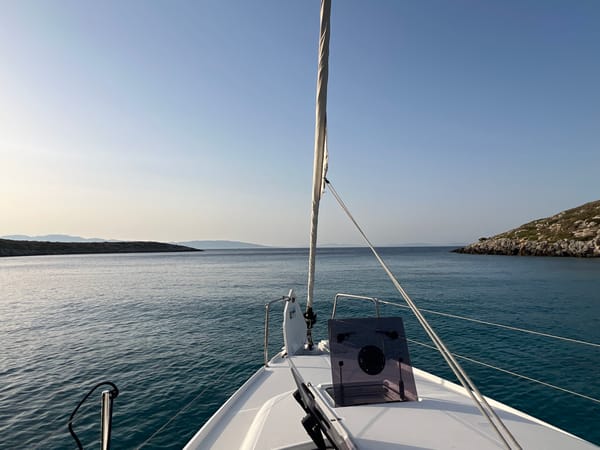 Sailing through calm open water on a clear day