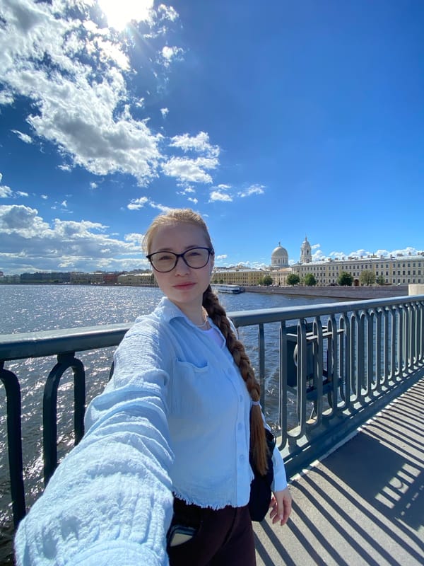 Sunny waterfront selfies with a glass skyscraper in the background
