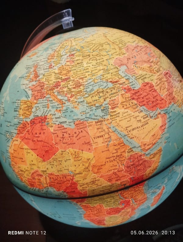 Close-up photograph captures colorful globe showing Europe, Africa, Asia