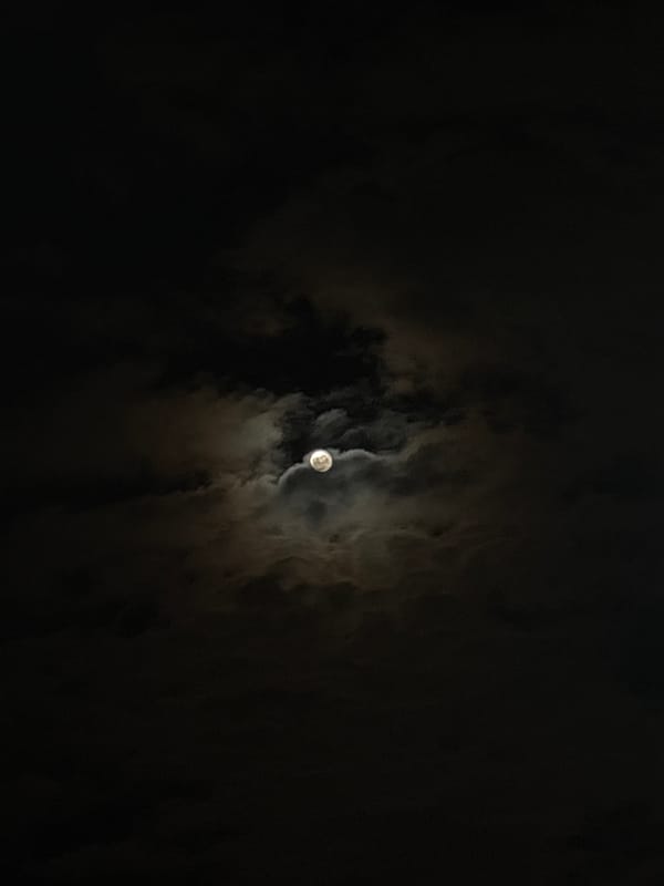 Full moon visible through clouds over Varna, Bulgaria