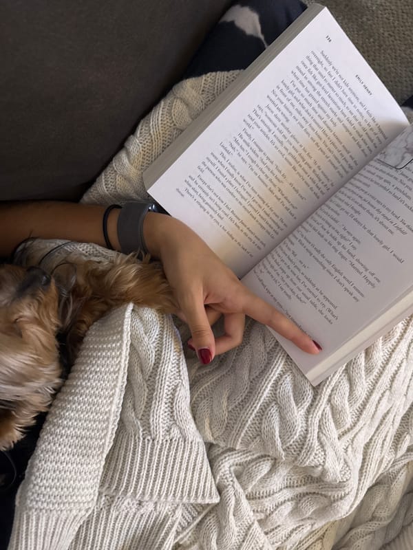Reader enjoys quiet evening with book and dog companion