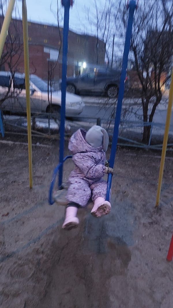 Child plays on swings at Novosibirsk playground