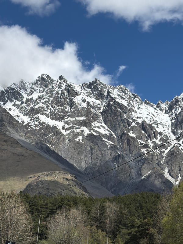 Snow-capped mountain with rocky face observed near Stepantsminda, Georgia