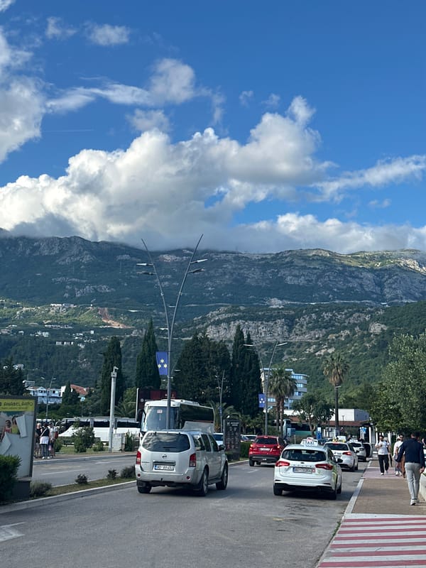 Tourist documents sunny afternoon exploring Budva, Montenegro coastal resort