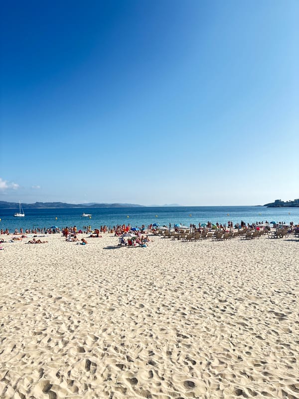 Sanxenxo beach and harbor on a busy summer afternoon