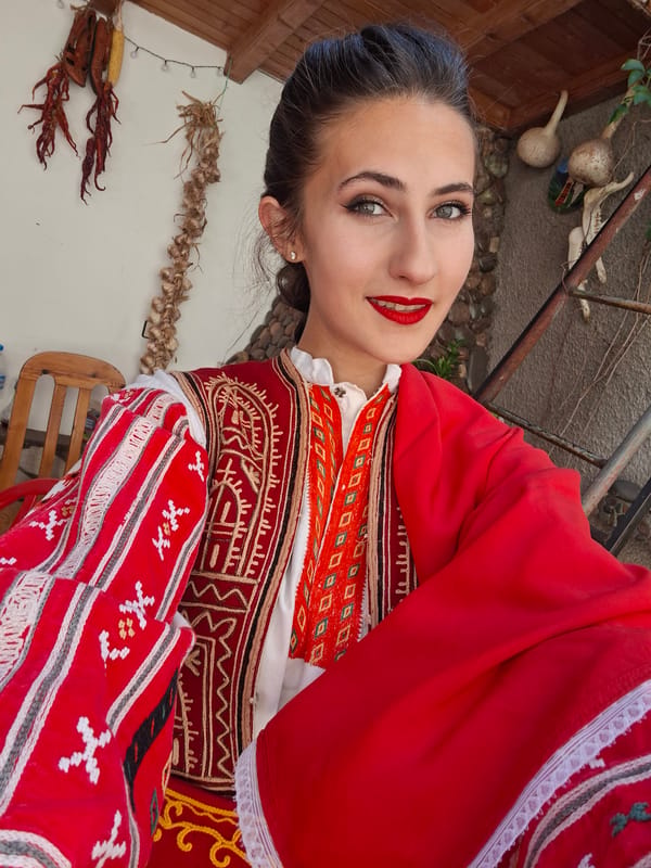 Traditional red embroidered outfit and a blooming cactus flower
