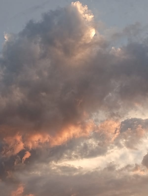 Almaty construction site glows under a dramatic summer sunset