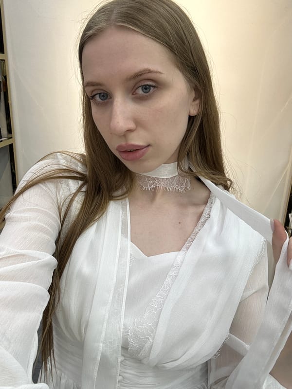 Woman takes selfie in clothing store dressing room