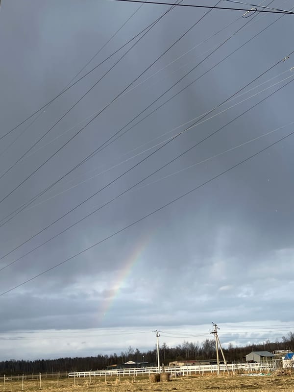 Faint rainbow appears over power lines in Razdol'e, Russia