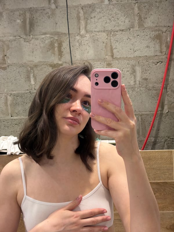 Woman takes selfies with pink phone in Chaikovsky