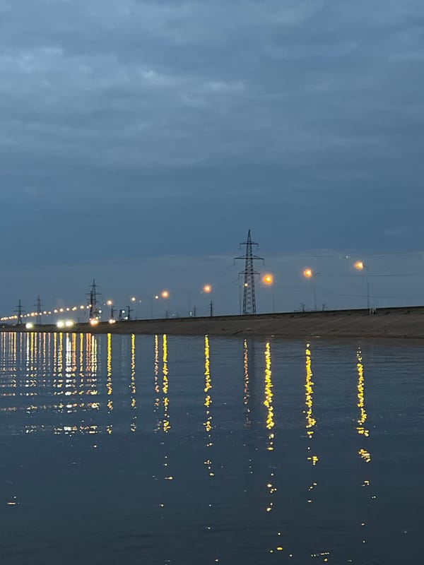 Waterfront evening in Noviy, Russia, Range Rover on sandy shore