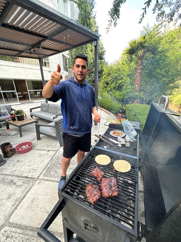 Man grills meat and tortillas outdoors in Mexico