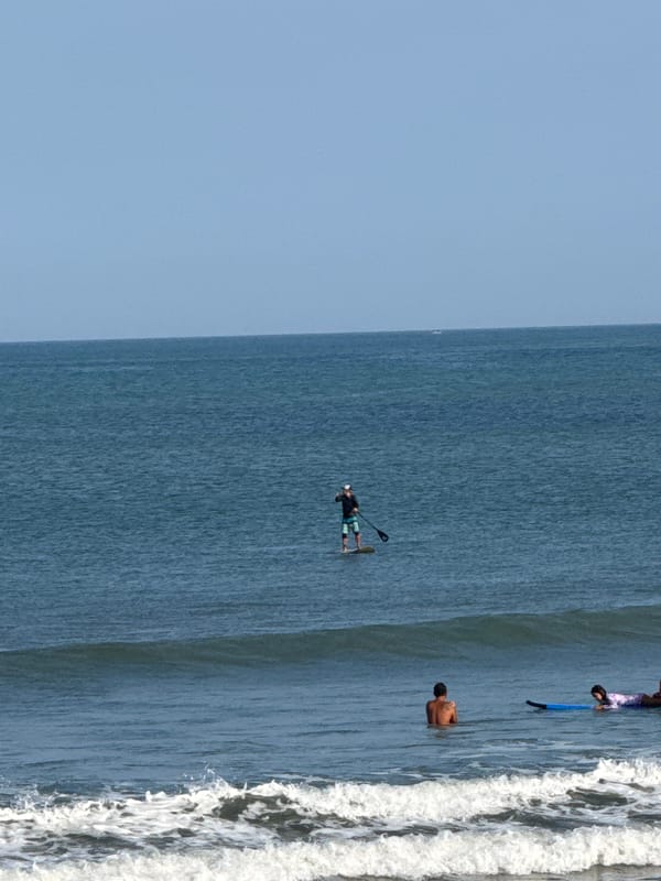 Surf session underway at Kuta Beach, Bali