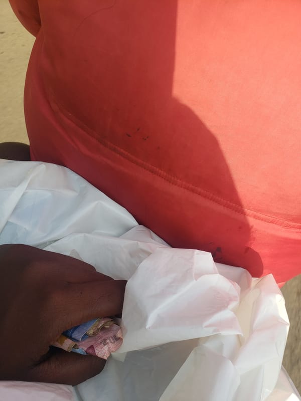 Person handles cash, belongings on Narayi roadway
