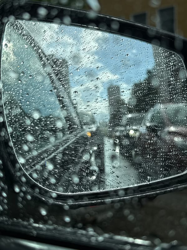 Driving through a rainy Kirov afternoon, streets slick and grey