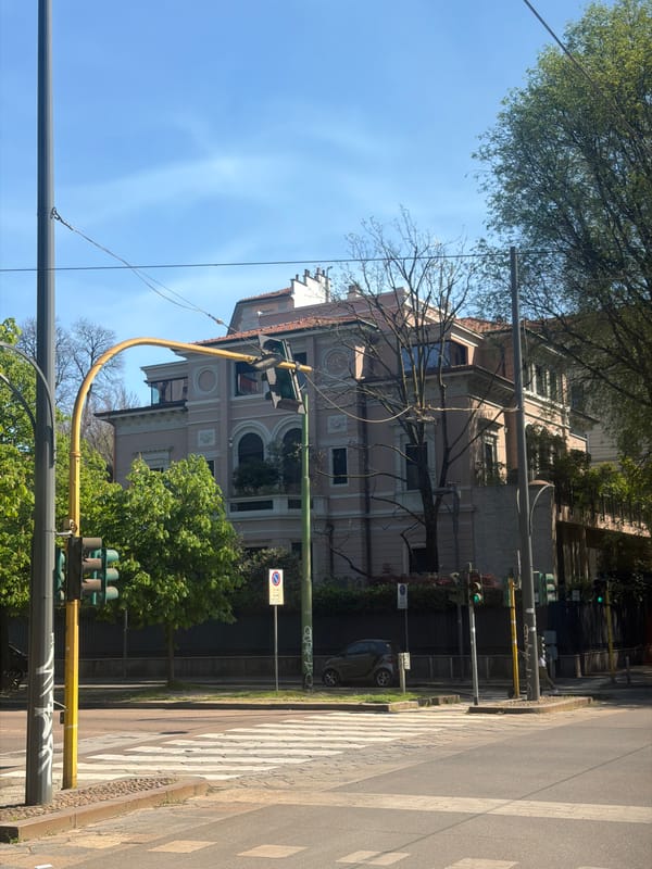 Ornate three-story residential building documented in Milan