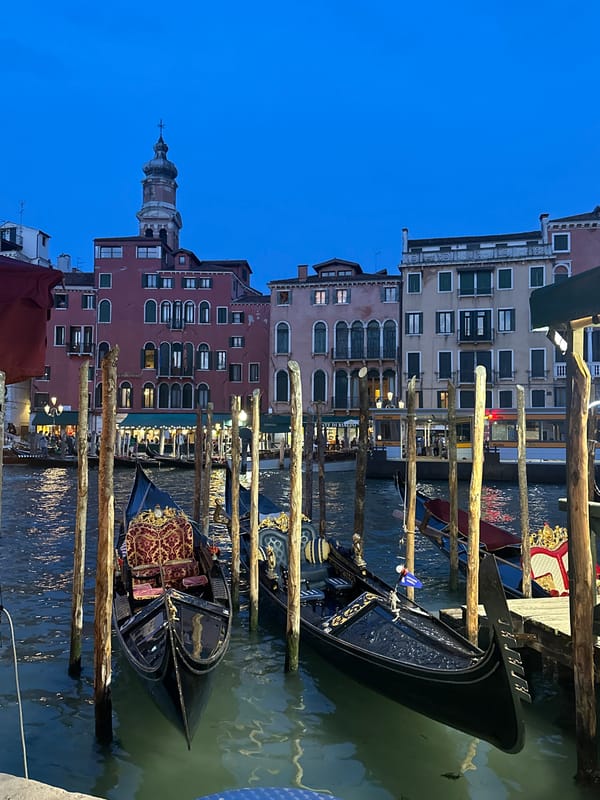 Evening gondolas moored along Venice canal at dusk