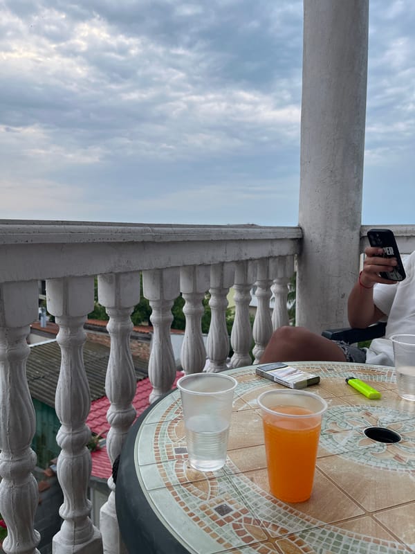 Two people relax on balcony in Chernomorets, Bulgaria