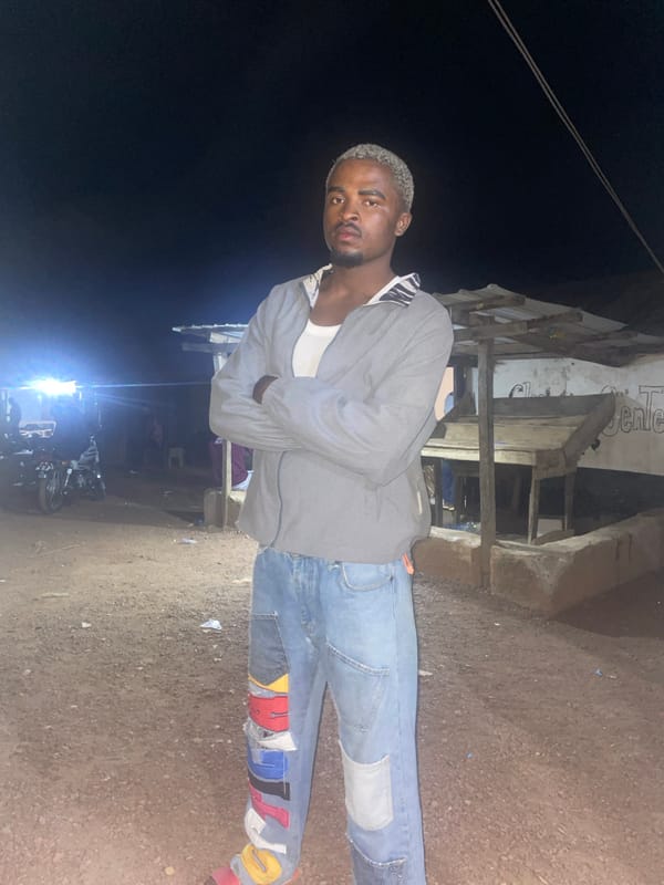 Man stands outside building at night in Durimi, Nigeria