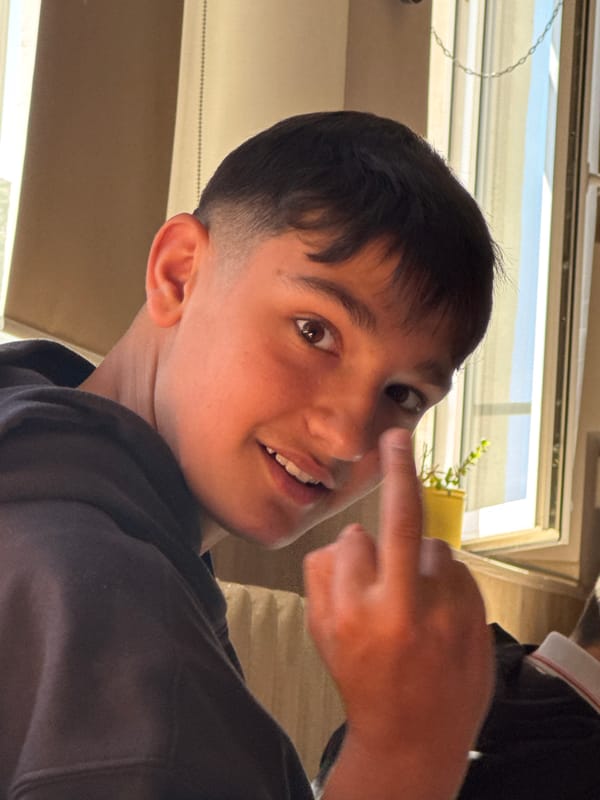 Boy photographed making playful gesture in Pazardzhik home
