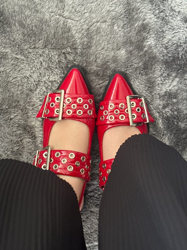 Person in red shoes poses for photos in Mexico City