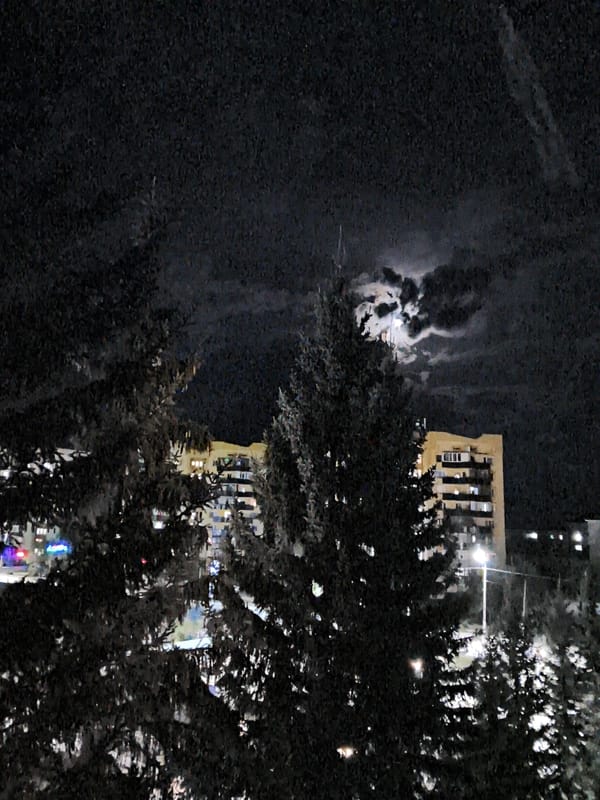 Moonlit night sky over Shchuchinsk with silhouettes below