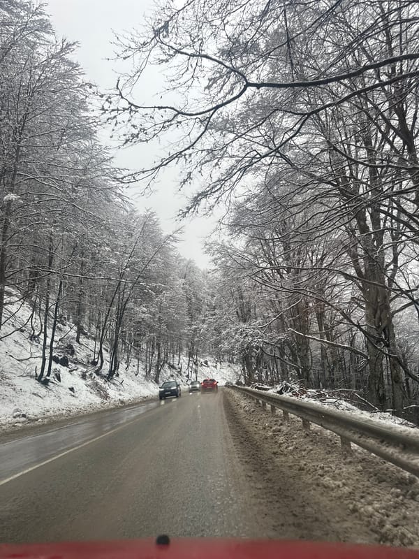 Red Mazda navigates snowy mountain road near Barziya, Bulgaria