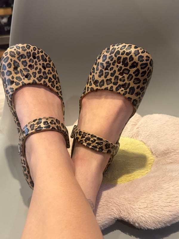 Person reading book in leopard print shoes, Podolsk
