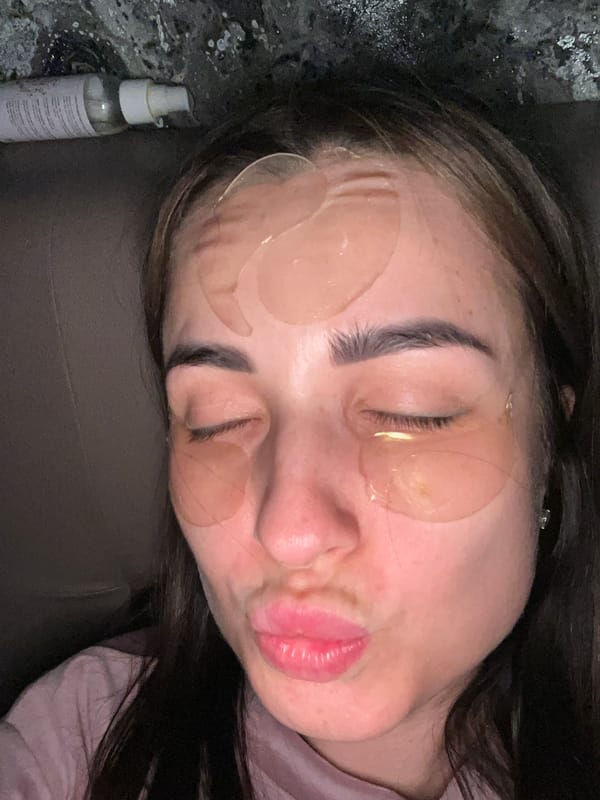 Woman receives facial treatment, white cat filmed at location